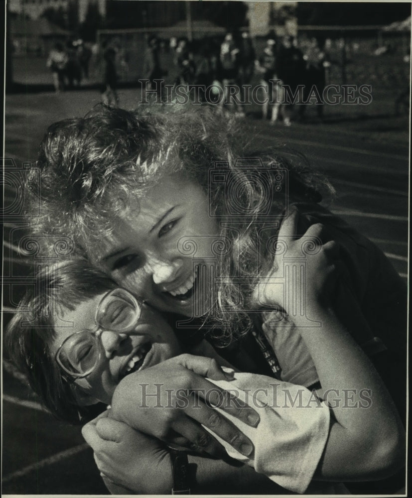 1988 Special olympian Rachel McNally was embraced by Susie Hintz - Historic Images