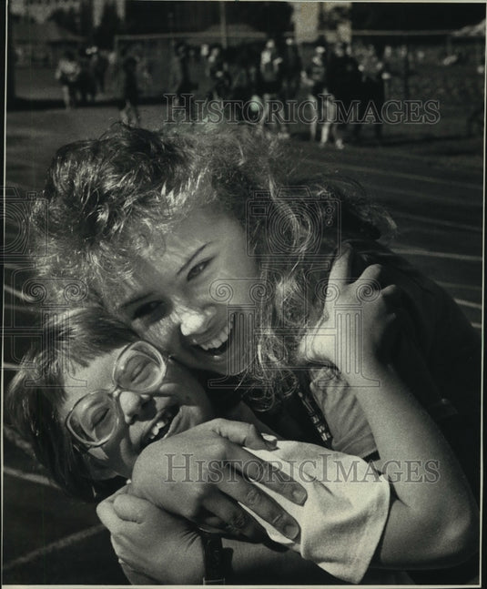 1988 Special olympian Rachel McNally was embraced by Susie Hintz - Historic Images