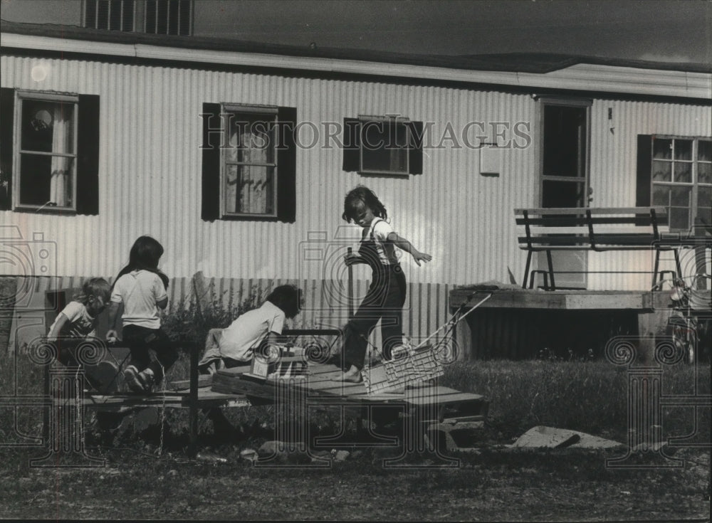 1976 Colstrip youngsters amuse themselves on their own. - Historic Images
