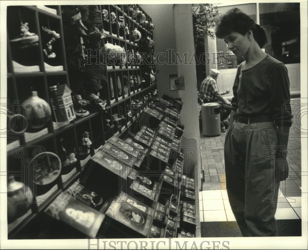 1990 Shopper looks at ornaments Betsy&#39;s Hallmark Grand Avenue Mall - Historic Images