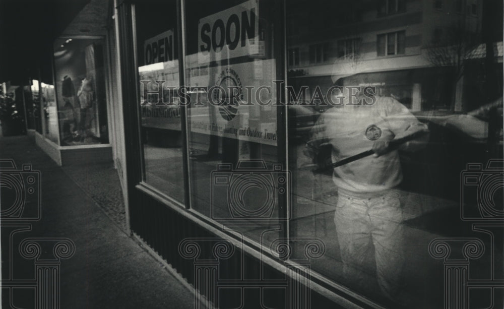 1993 Press Photo Walter Gottschalk puts final touches on Travel agent&#39;s store. - Historic Images