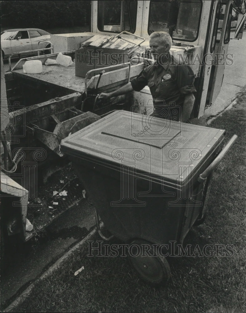 1977 Press Photo Evo operator Fillmore Bott unloads garbage. Shorewood Wisconsin - Historic Images