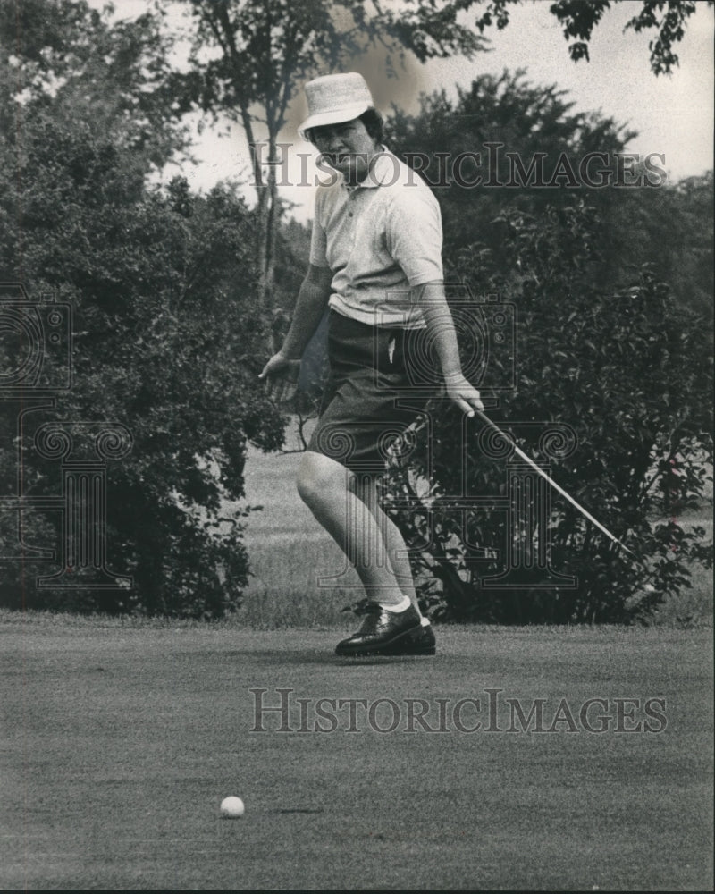 1963 Louise Suggs watches golf ball roll toward the cup.-Historic Images