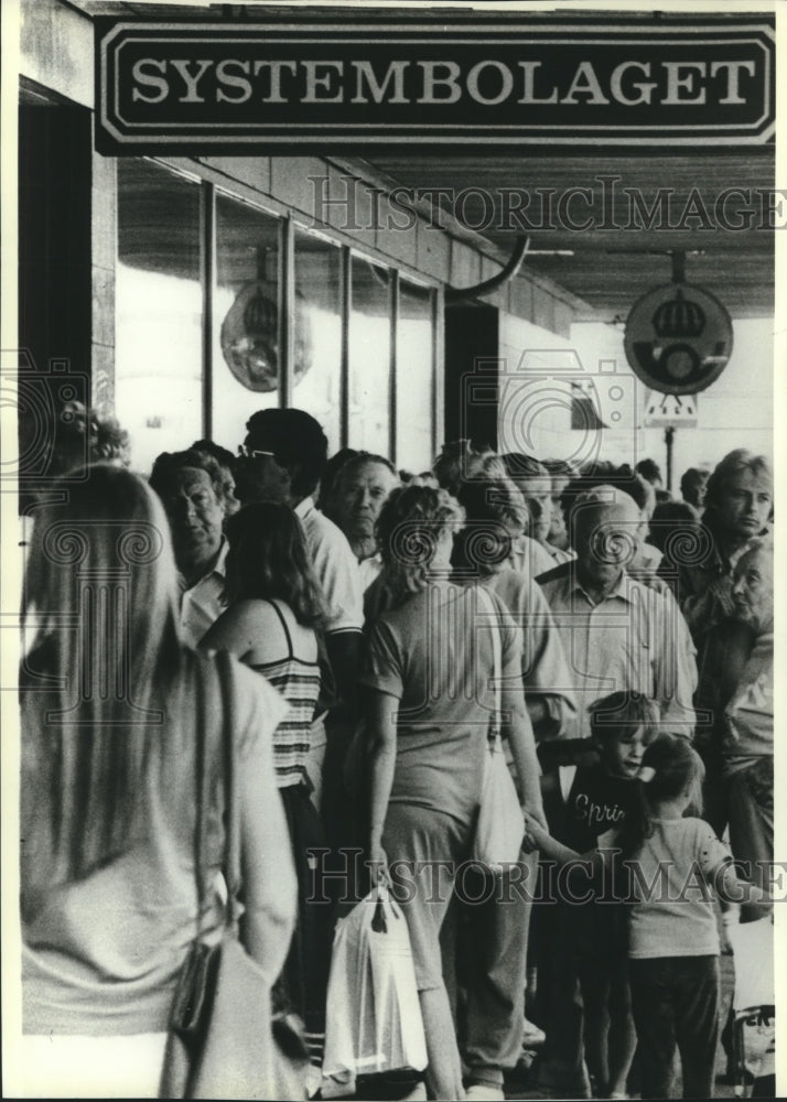 1989 Lines of people outside liquor store, Stromstad Sweden - Historic Images