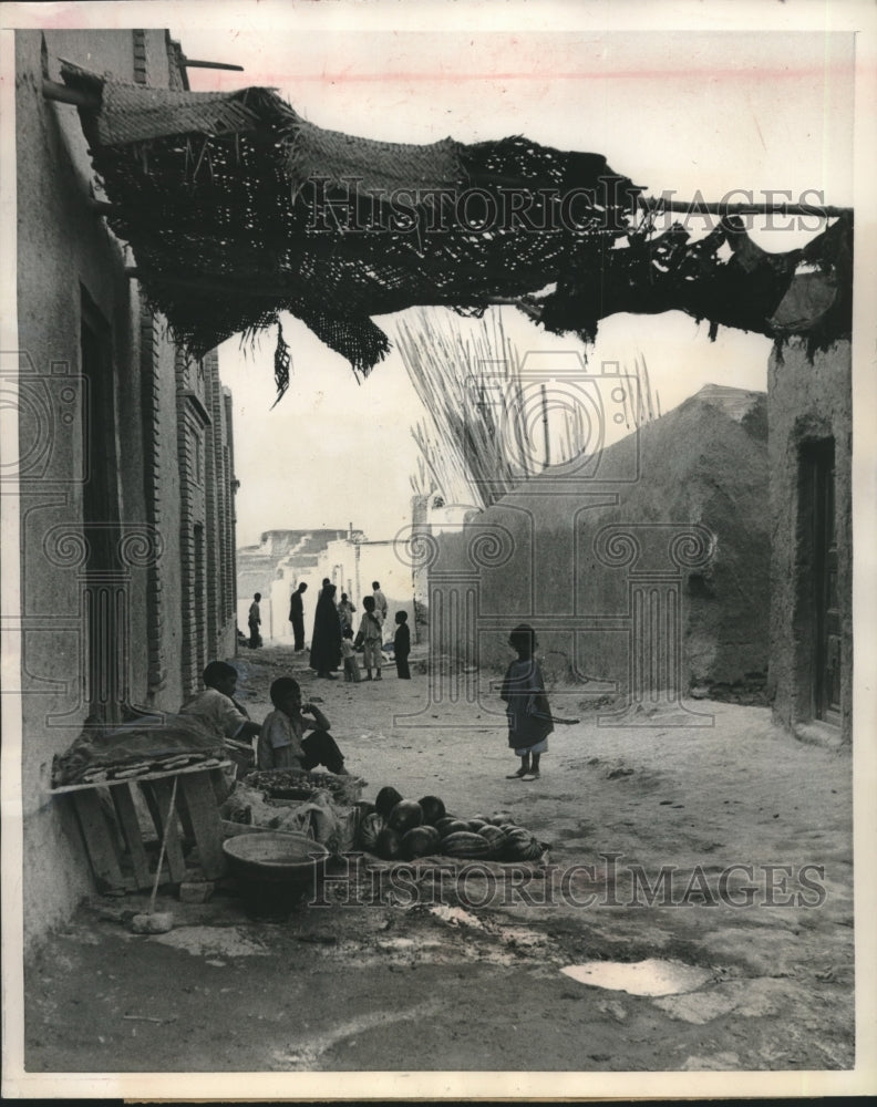 1951 Press Photo Two boys run a Tehran fruit and vegetable stand on a dirt alley - Historic Images