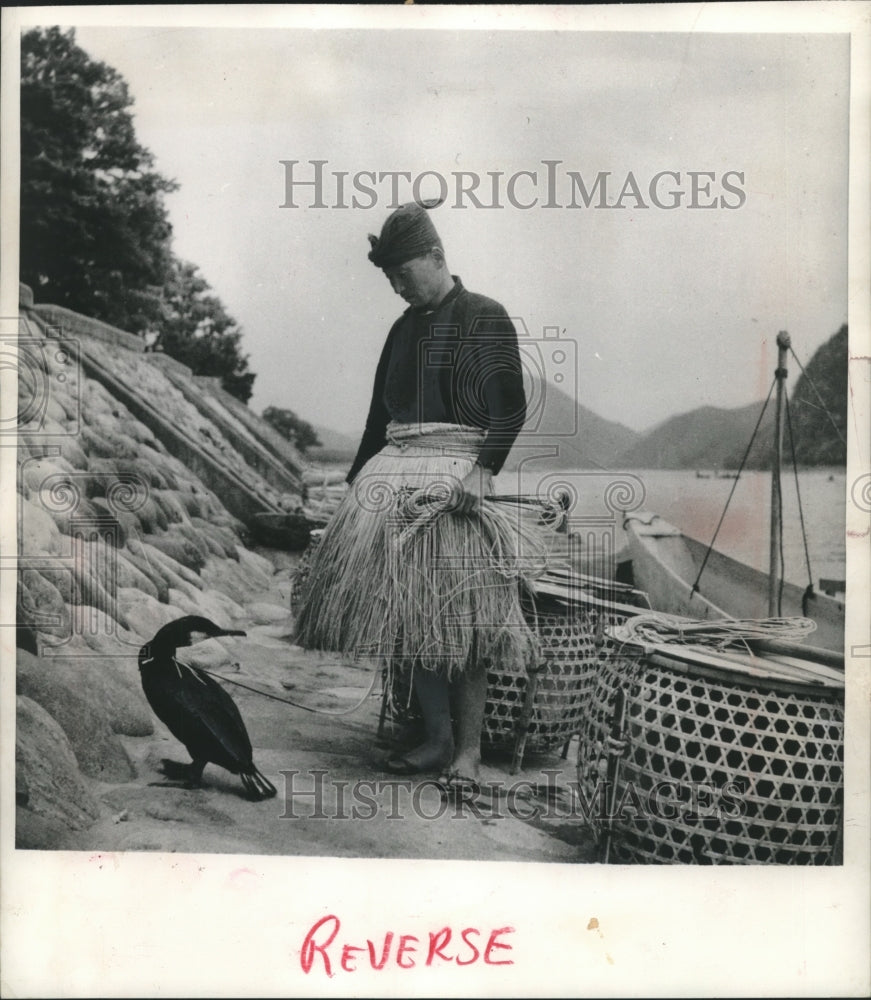 1953 Press Photo A Master Cormorant Fisherman examines one of his birds Japan - Historic Images