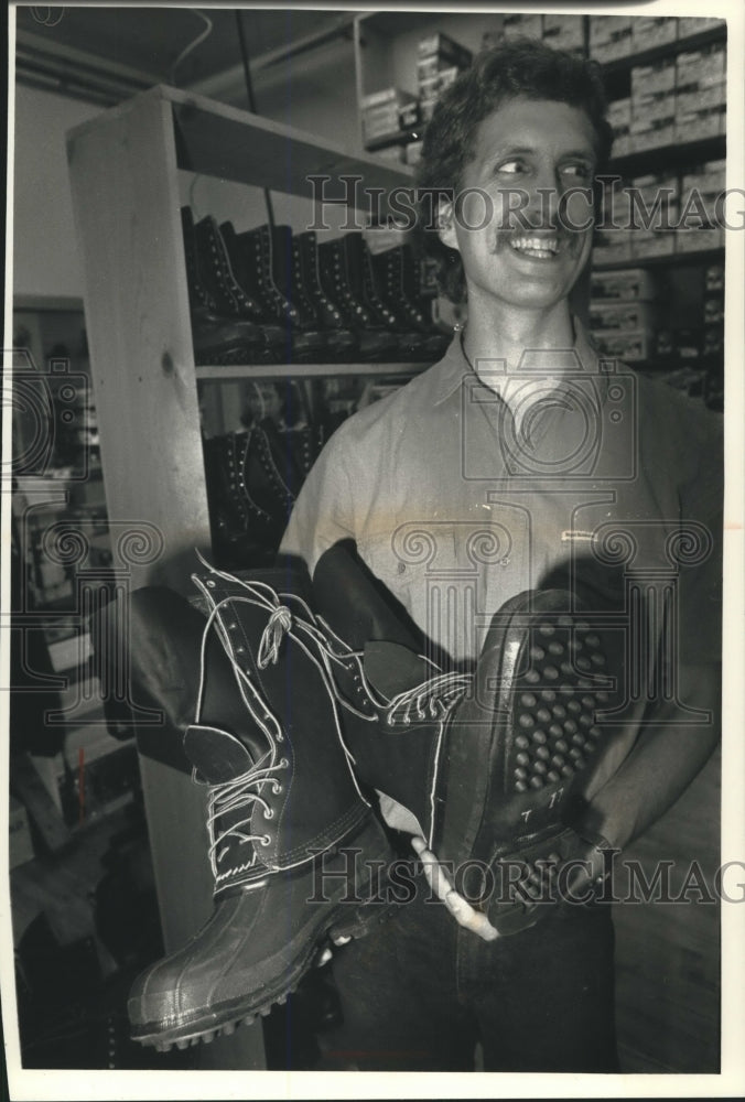 1991 Press Photo Man holding a pari of Schnee&#39;s Boots for hunting - mjb98436 - Historic Images