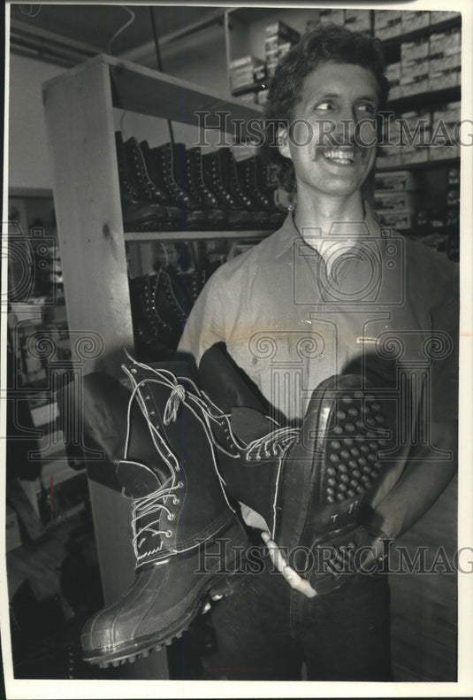 1991 Press Photo Man holding a pari of Schnee's Boots for hunting - mjb98436 - Historic Images