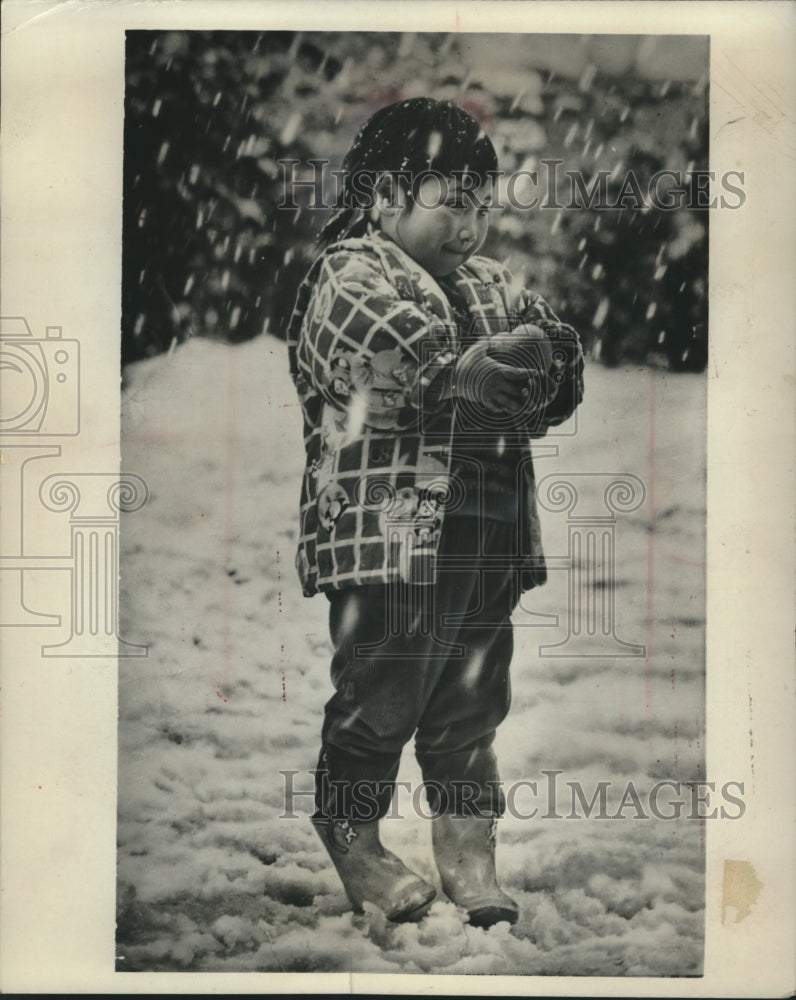 1963 Press Photo Young Japanese girl walking in snow carries apple, Aomori- Historic Images
