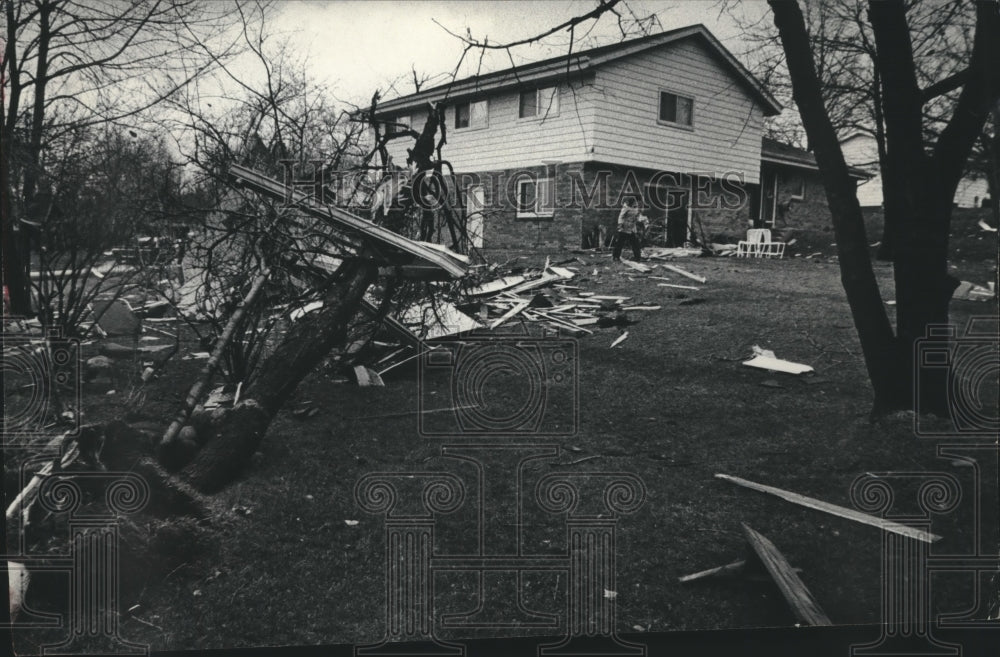 1977 Press Photo Resident checks tornado damaged property, Brookfield Wisconsin. - Historic Images