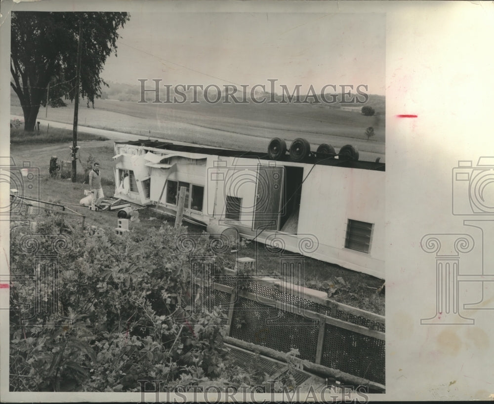 1963 Press Photo Dean Held going through his tornado damaged home, Wisconsin. - Historic Images