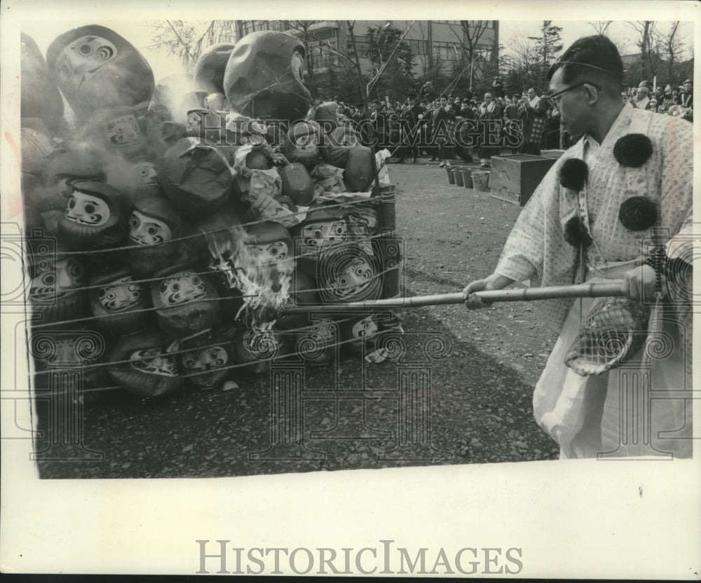 1965 Press Photo Japanese man burns a pile of spirit masks, Japan - mjb98946 - Historic Images