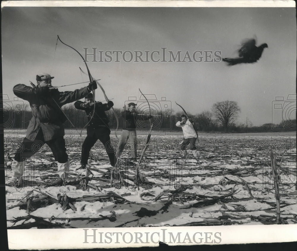 1957 Press Photo Men with bows hunt pheasant. - mjb99133 - Historic Images
