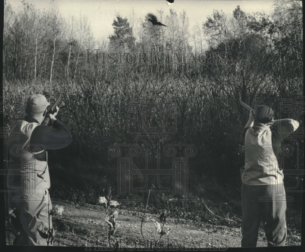 Press Photo The Schmitts aim at a flying pheasant. - mjb99134-Historic Images