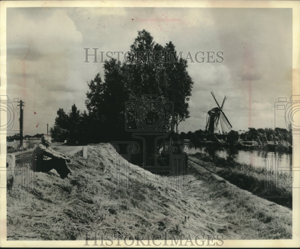 1962 Press Photo A person viewing windmill a few miles from Amsterdam, Holland.-Historic Images