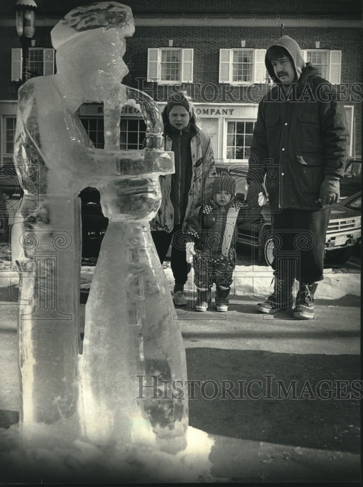 1992 Duren family enjoys ice sculpture in West Bend - Historic Images