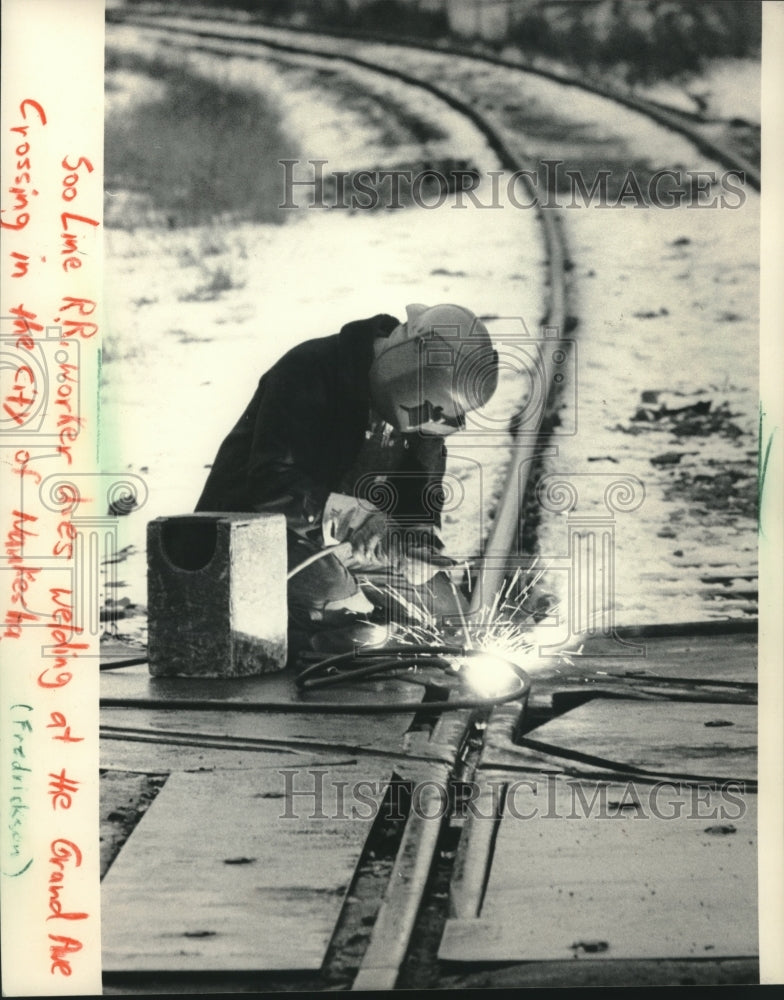 1984 Welder works on Soo Line train tracks at Grand Ave in Waukesha - Historic Images