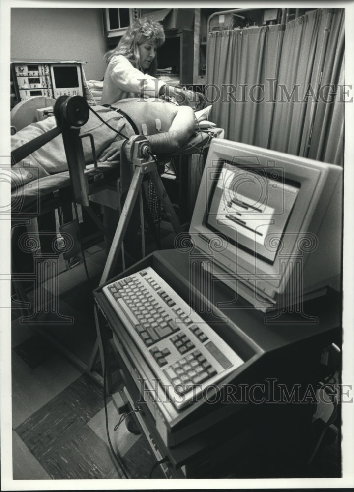 1990 Press Photo Jill Barney of SORBA Adjusting Electrodes on Patient, Wauwatosa - Historic Images