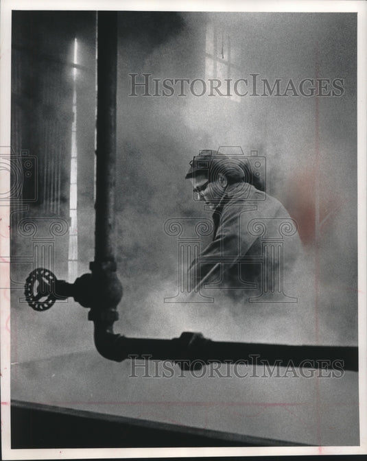 1963, Mrs. Glen Schlueter tended sorghum steam cookers in mill - Historic Images