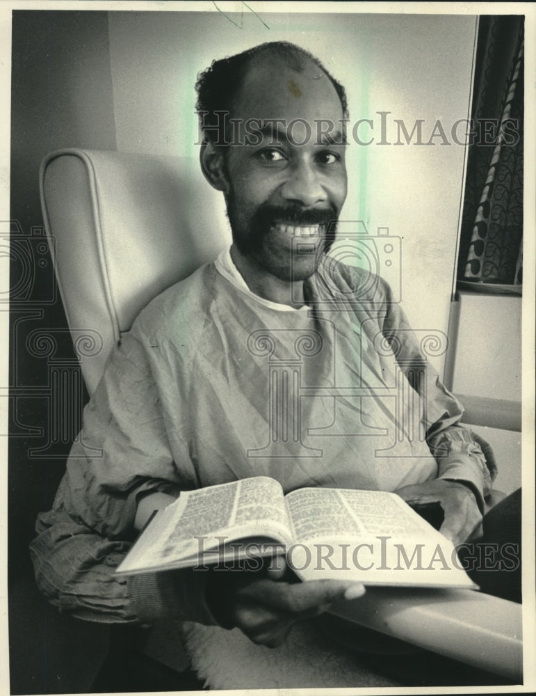 1987 Ronald L. Smith Reads Bible in His Room at St. Luke's Hospital - Historic Images