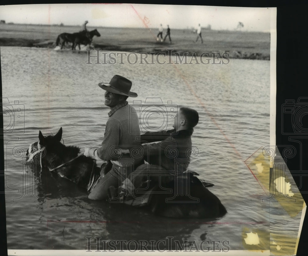 1955 Press Photo A boy held on as a horse forded water that blocked the path-Historic Images