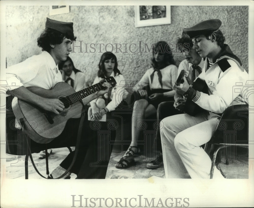 1975 Young Russian counselors and campers gather for song session - Historic Images