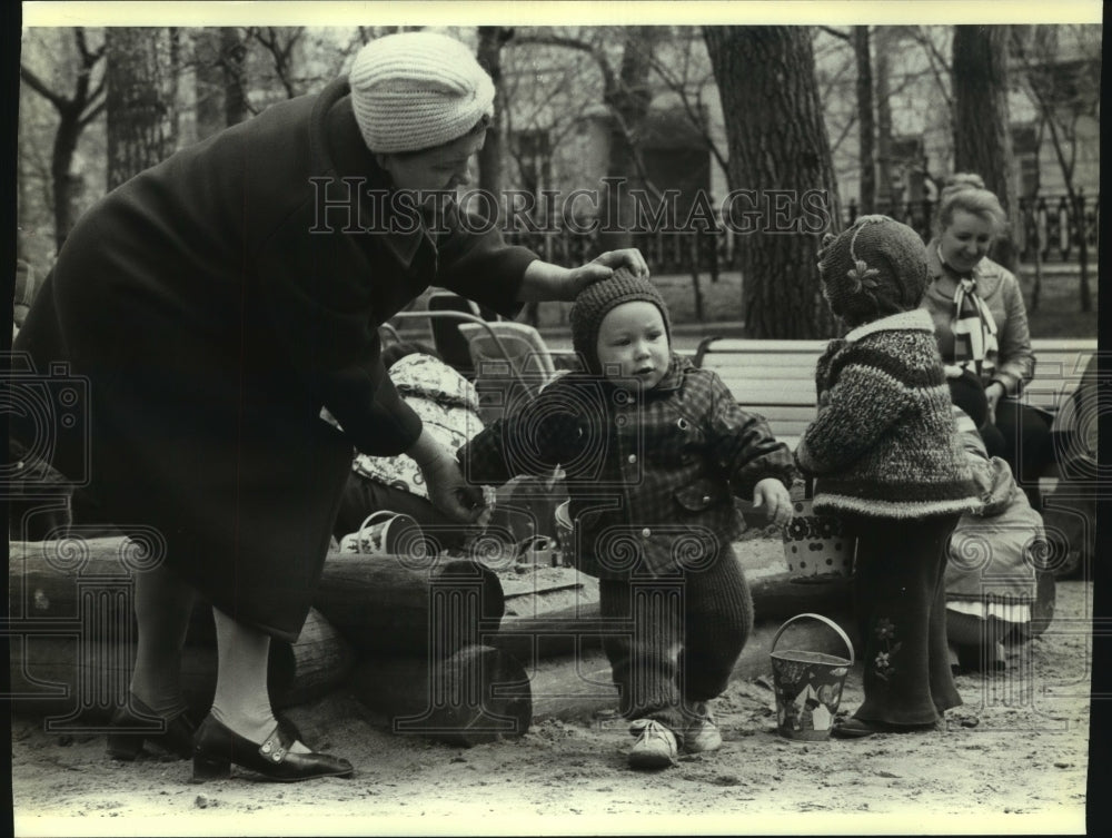 1979 A babushka fussed over a toddler at a playground in Russia - Historic Images