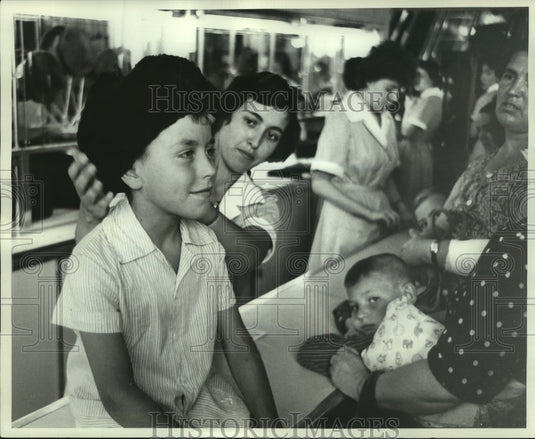 1961 Vova Bogayev tries on Shapka Cap at Children's World in Moscow - Historic Images