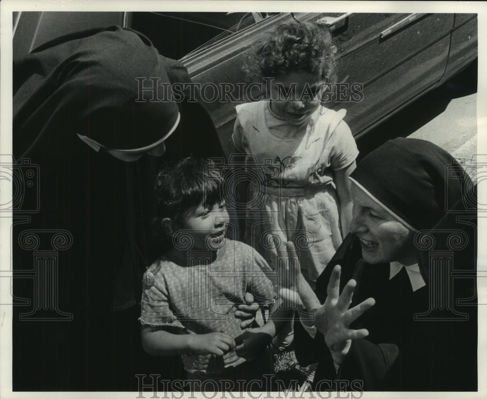 1965, Sister Mary Janet talking with children at Mary Immaculate - Historic Images