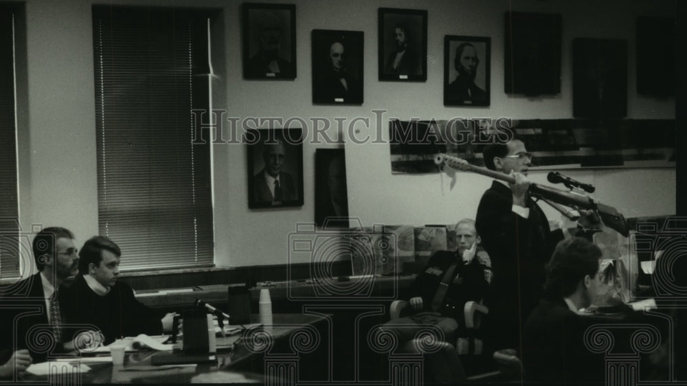1995, Accused and attorney in court, DA holds "Thor" rifle, Waukesha. - Historic Images