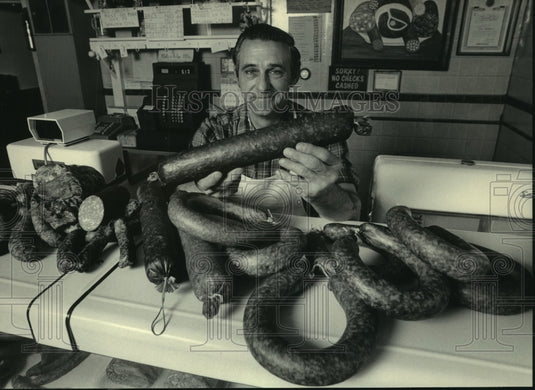 1986, Walter Otto displays products at Otto's Sausage Shop-Germantown - Historic Images