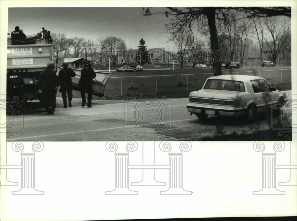 1994 James Oswald; police take cover behind vehicle - Historic Images