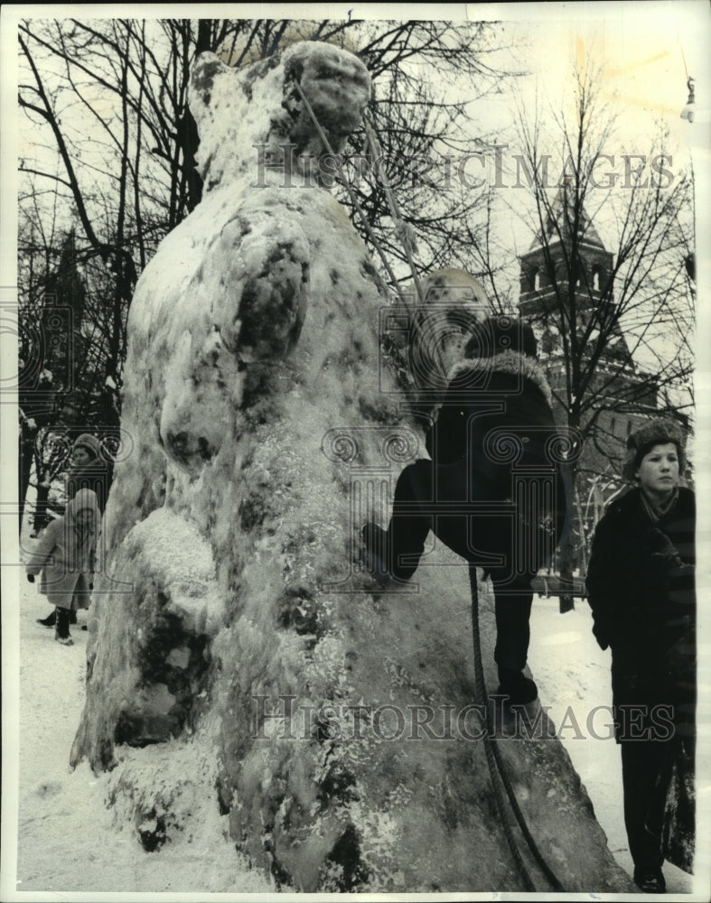 1963 Press Photo Youngster Trying to Climb Huge Ice Bear in Russia - mjc02348 - Historic Images