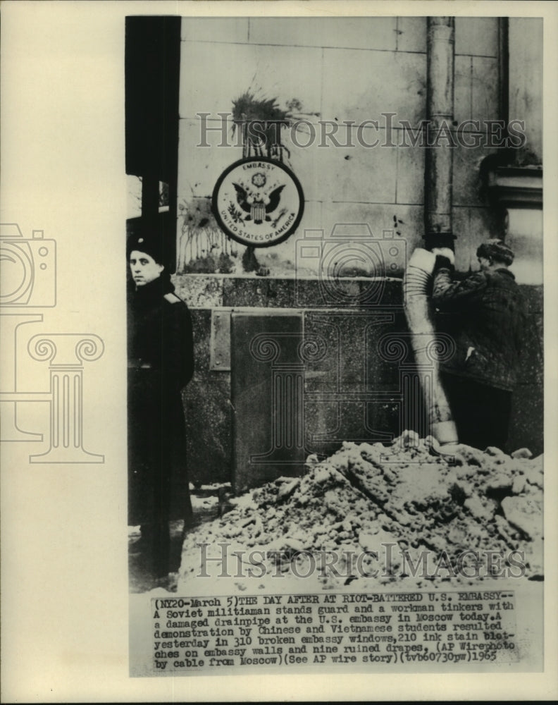 1965 Press Photo Soviet Militiaman Stands Guard, Workman Tinkers With Drainpipe - Historic Images