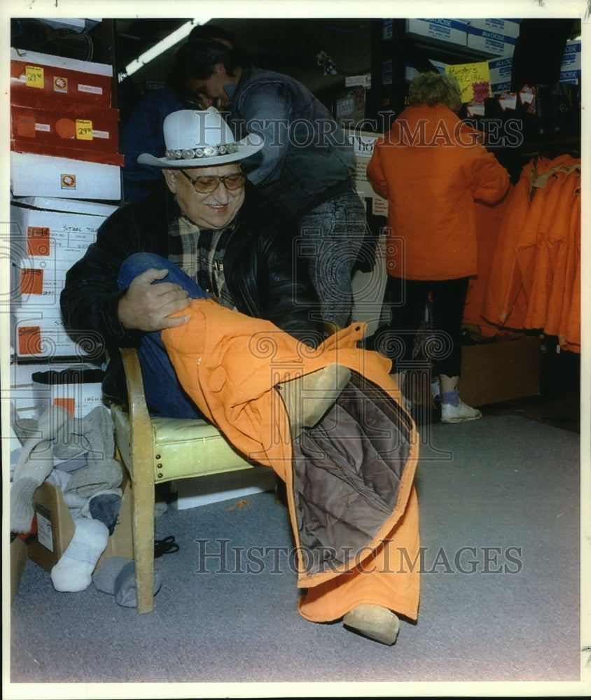 1993, Ray Maze of Chicago Tries on Orange Attire in Hales Corner - Historic Images