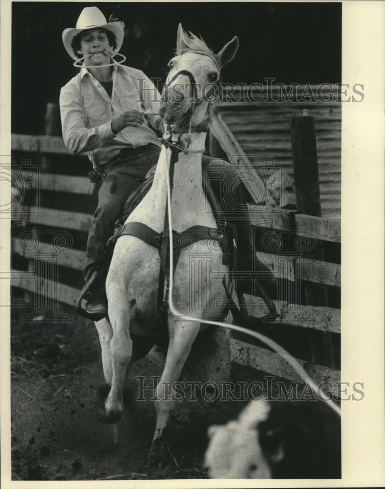 1984 Rodeo cowboy, Dan Myers, lassos a calf at the Milwaukee Rodeo - Historic Images