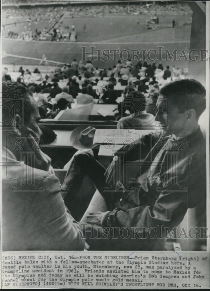 1968 Press Photo Brian Sternberg talks with spectator at Olympics, Mexico City. - Historic Images