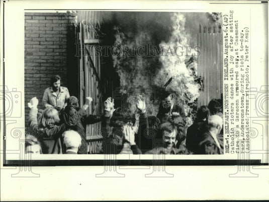 1972 Belfast Catholic rioters dance after setting fire to armor car - Historic Images