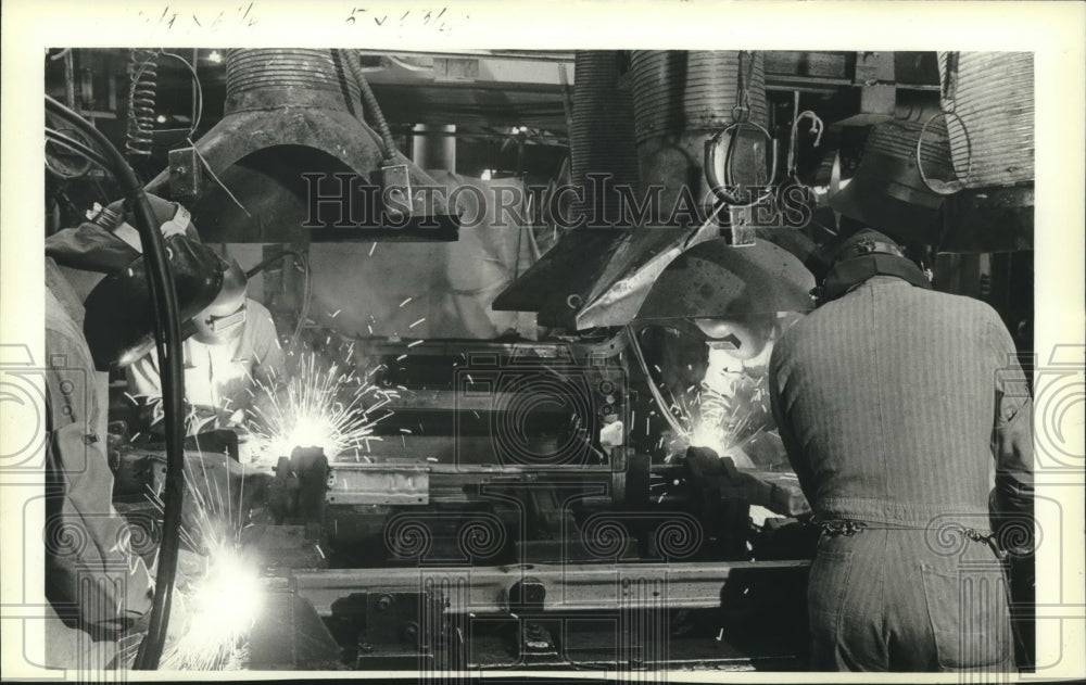 1983 Welders work on automobile frames at A.O. Smith Corp, Milwaukee - Historic Images