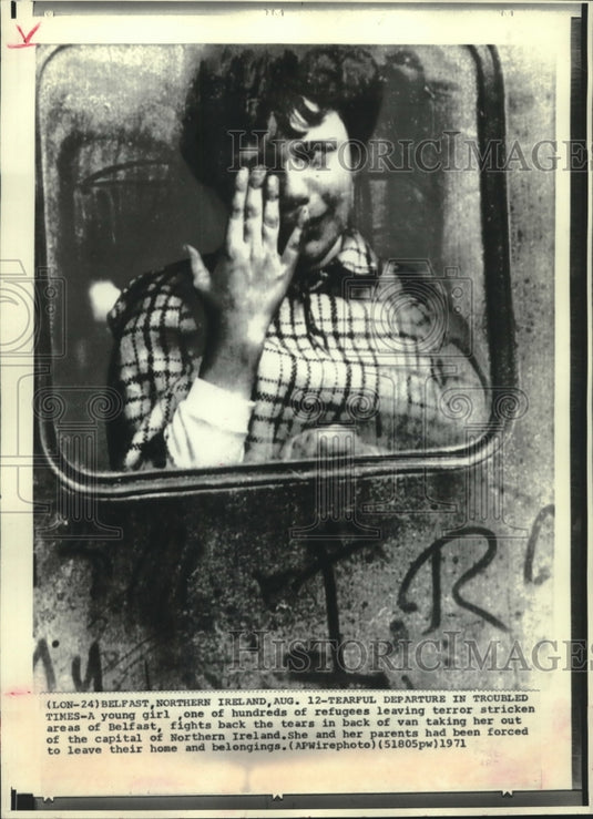 1971 Press Photo Girl wiping away tears in van leaving home, Northern Ireland.-Historic Images