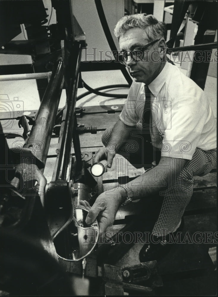 1981, Engineer Allen Malsack of A.O. Smith in Milwaukee checks axles - Historic Images