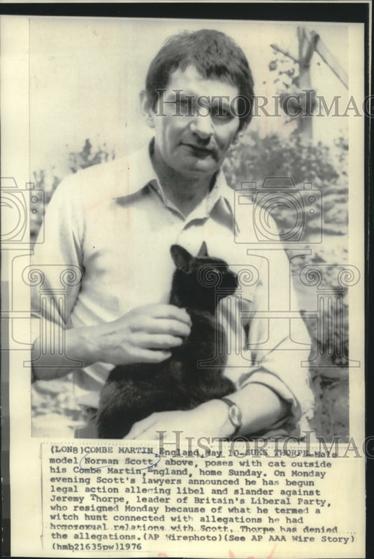 1976 Norman Scott and cat at his Combe Martin, England home - Historic Images