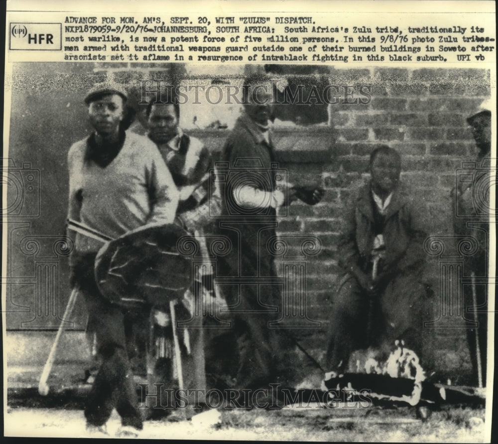 1976, Zulu tribesmen guard burned building in Soweto, South Africa - Historic Images
