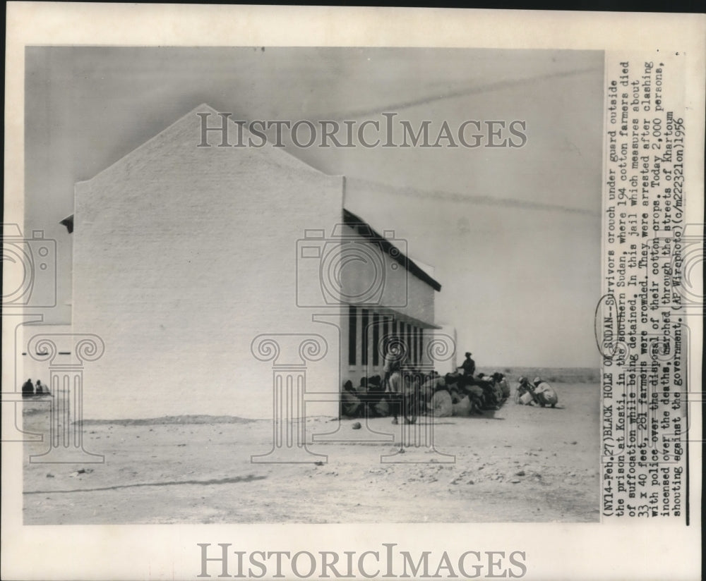 1956, Survivors Crouch Under Guard Outside Prison at Kosti in Sudan - Historic Images