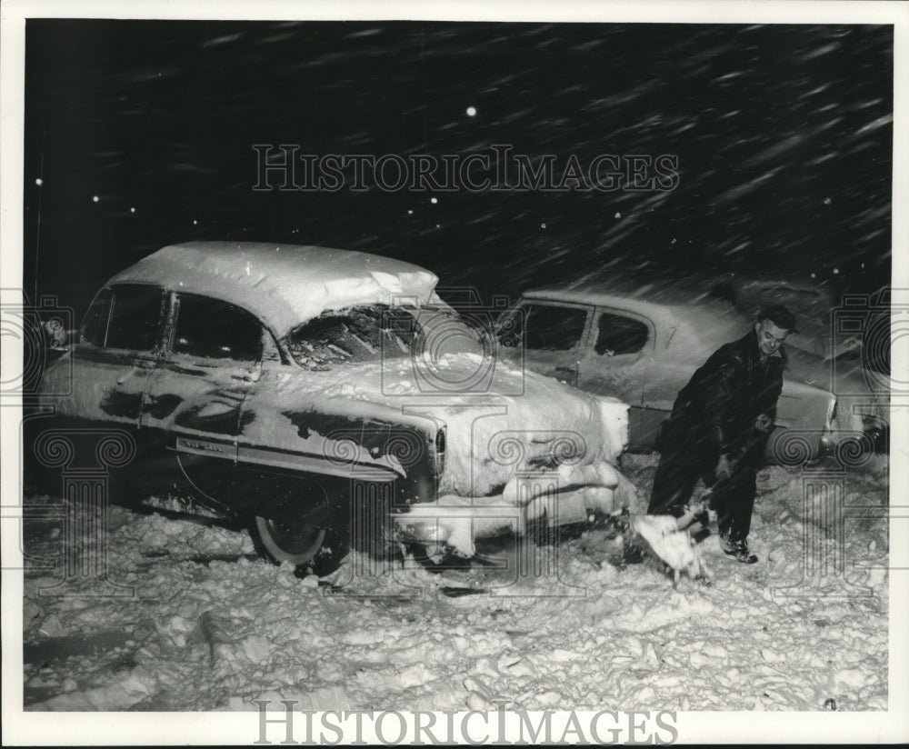 1962 Man digging out after big snow storm in Milwaukee, Wisconsin. - Historic Images