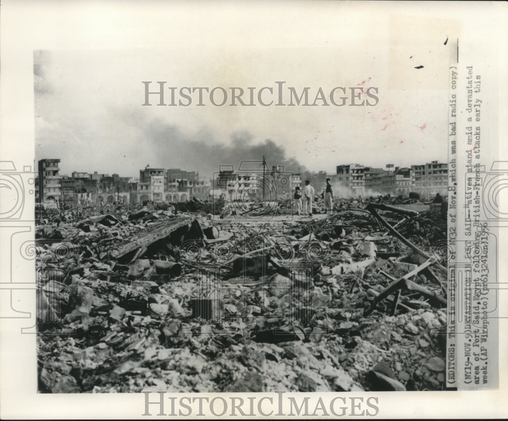 1956, Natives stand amid a devastated area of Port Said, Egypt - Historic Images