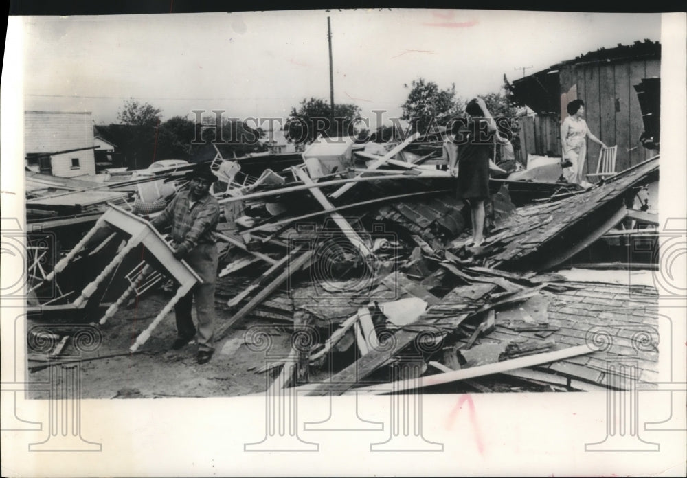 1966, Guillermo Carrisalez salvages table after tornado in Kenedy, TX - Historic Images