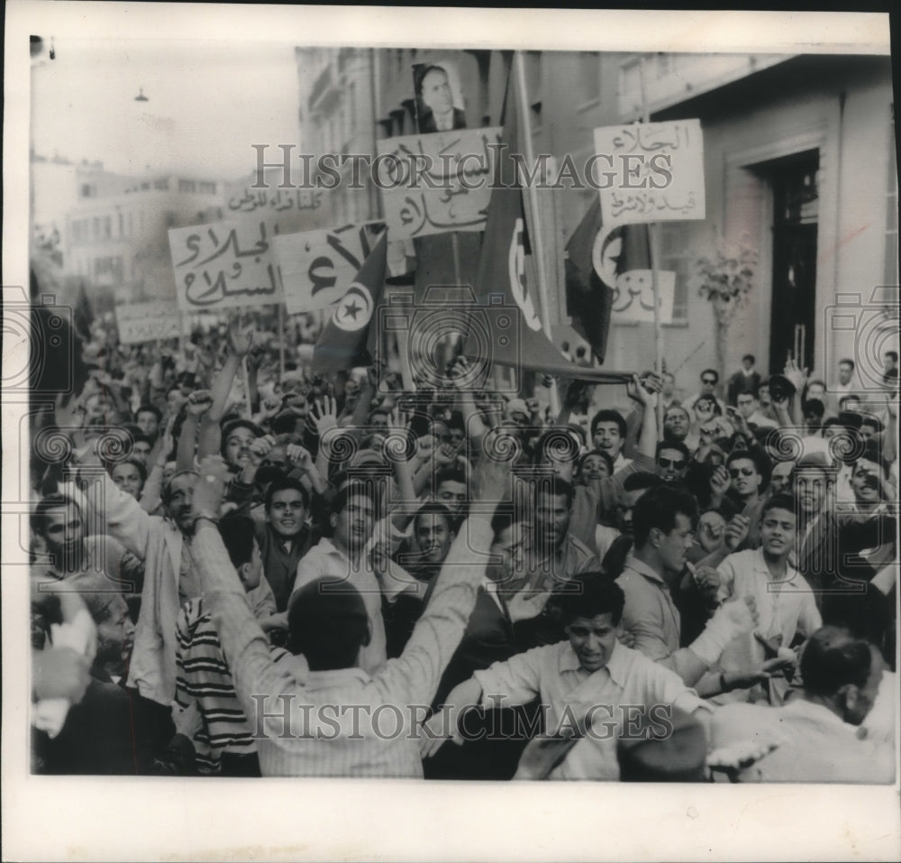 1958, Shouting mob riots against bombing by the French in Tunisia. - Historic Images