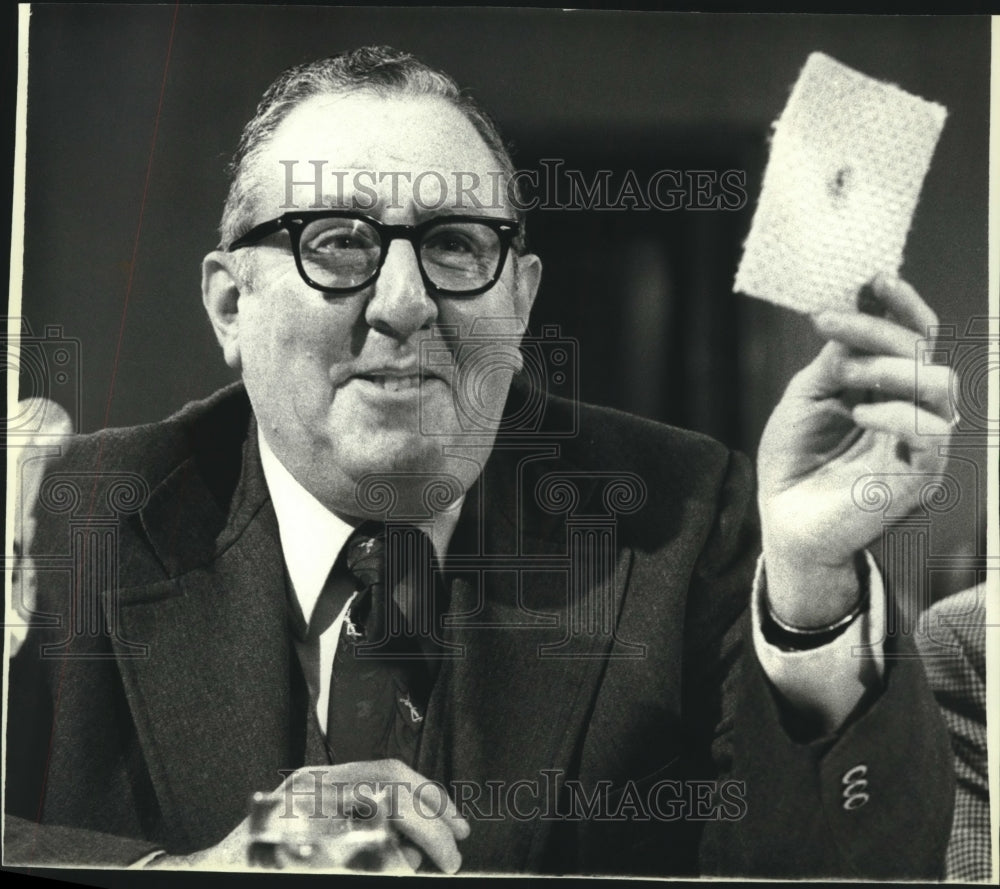 1979 Jerome Stolarow, procurement officer, holds bullet-proof item - Historic Images