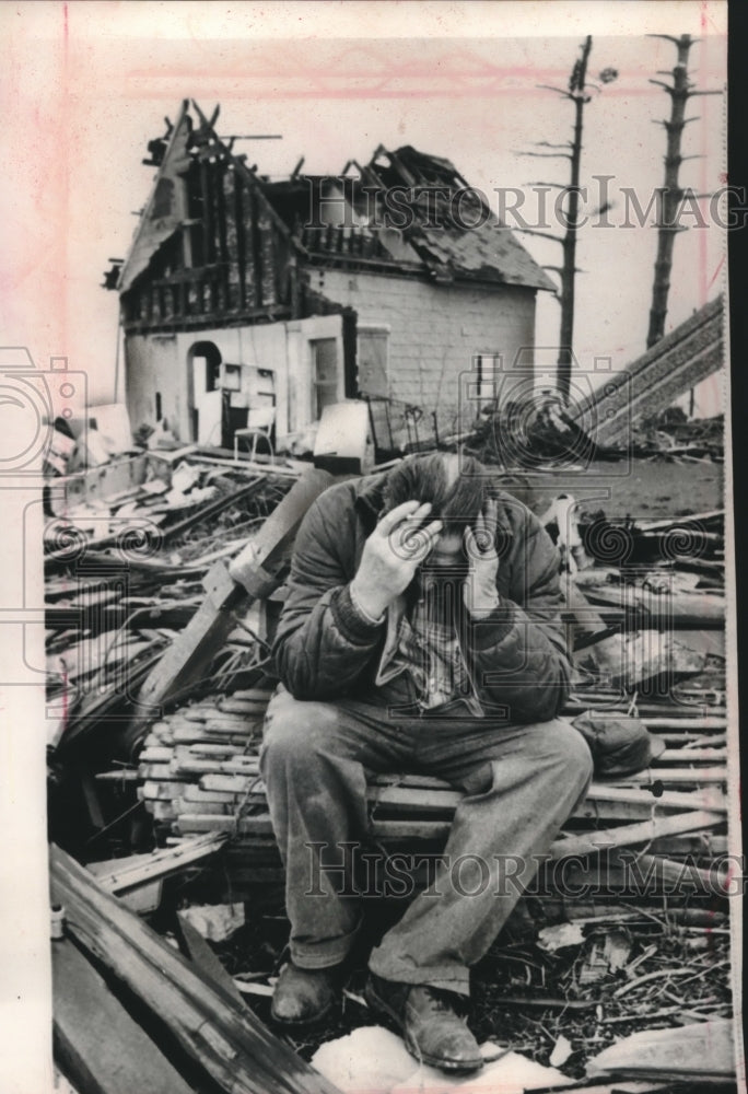 1965, Elam Smith sits among rubble of his home after tornado - Historic Images